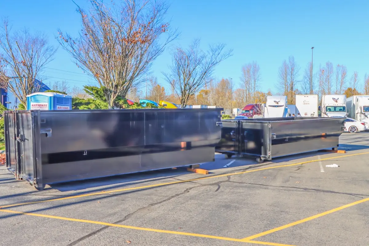 Professional dumpster rental service with roll-off container on residential driveway in Hopewell